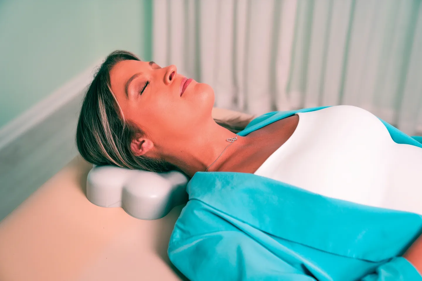 Woman wearing a blue blazer laying down